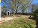 Expansive backyard with green grass and a shed, perfect for outdoor enjoyment and storage at 4210 Runaway Cir, Monroe, NC 28110