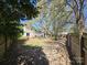 Large, fenced backyard featuring mature trees and ample space for outdoor activities at 4210 Runaway Cir, Monroe, NC 28110