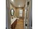 Bathroom featuring double sinks with framed mirrors, cabinets, tile flooring, and a modern toilet at 4210 Runaway Cir, Monroe, NC 28110