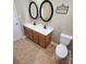Bathroom featuring double sinks with framed mirrors, cabinets, tile flooring, and a modern toilet at 4210 Runaway Cir, Monroe, NC 28110