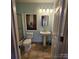 Cozy bathroom featuring a stand-alone sink, shower, and decorative mirror at 4210 Runaway Cir, Monroe, NC 28110