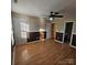 Bedroom with hardwood floors, two-tone walls, a ceiling fan and an ensuite bathroom with a partial view at 4210 Runaway Cir, Monroe, NC 28110