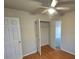 Bedroom featuring a ceiling fan, light-colored walls, hardwood flooring, and a closet with open doors at 4210 Runaway Cir, Monroe, NC 28110