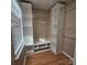 Walk-in closet with built-in shelving, and hanging rods for storage, with natural light from a window at 4210 Runaway Cir, Monroe, NC 28110