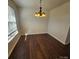A light-filled dining room featuring hardwood floors and a modern chandelier at 4210 Runaway Cir, Monroe, NC 28110