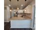 Kitchen island featuring stainless appliances, granite countertops, and modern pendant lighting at 4210 Runaway Cir, Monroe, NC 28110