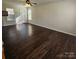 Bright living room showcasing gleaming hardwood floors and natural light through the window at 4210 Runaway Cir, Monroe, NC 28110