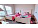 Cozy bedroom with twin beds and bright, natural lighting at 4253 Stream Dale Nw Cir, Concord, NC 28027