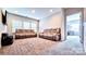 Upstairs bonus room featuring 2 sofas and an open door to an adjacent bedroom at 4253 Stream Dale Nw Cir, Concord, NC 28027