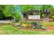 Hunton Forest entrance sign surrounded by colorful flowers and lush green landscaping at 4253 Stream Dale Nw Cir, Concord, NC 28027