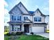 Charming two-story home with stone accents, a well-manicured lawn, and a welcoming front porch at 4253 Stream Dale Nw Cir, Concord, NC 28027