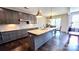 Stylish kitchen featuring gray cabinets, a granite island, and modern pendant lighting at 4253 Stream Dale Nw Cir, Concord, NC 28027
