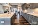 Well-designed kitchen boasting gray cabinets, granite countertops, and stainless steel appliances at 4253 Stream Dale Nw Cir, Concord, NC 28027