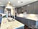 Modern kitchen featuring gray cabinets, granite countertops, and stainless steel appliances at 4253 Stream Dale Nw Cir, Concord, NC 28027