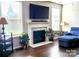Cozy living room with fireplace, large TV, and lots of natural light through bright windows at 4253 Stream Dale Nw Cir, Concord, NC 28027