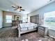 Spacious main bedroom featuring a ceiling fan, ensuite bath, and large windows at 4253 Stream Dale Nw Cir, Concord, NC 28027