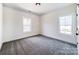 Bright, carpeted bedroom with two windows providing natural light at 4262 Brandy Creek Ct, Clover, SC 29710