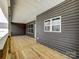 A view of the large back deck, showing gray siding and double-hung windows at 4262 Brandy Creek Ct, Clover, SC 29710