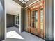 A grand entrance with a stained wood front door and covered porch at 4262 Brandy Creek Ct, Clover, SC 29710