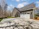 A side view of the house, featuring a clean, two-car garage with a wide driveway at 4262 Brandy Creek Ct, Clover, SC 29710