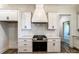 Well-equipped kitchen boasts a stainless steel stove with range hood, white cabinetry, and tile backsplash at 4262 Brandy Creek Ct, Clover, SC 29710