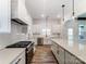 Bright kitchen boasts of stainless steel appliances, white cabinets, and a kitchen island at 4262 Brandy Creek Ct, Clover, SC 29710