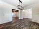 Open-concept room featuring decorative lighting, wainscoting, and hardwood flooring at 4262 Brandy Creek Ct, Clover, SC 29710