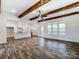 Open-concept living area with wood beam ceilings and kitchen with modern appliances at 4262 Brandy Creek Ct, Clover, SC 29710