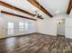 Light-filled living area with wood floors, wood beam ceiling and an open floorplan at 4262 Brandy Creek Ct, Clover, SC 29710