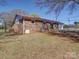 Backyard showing a brick exterior, grass area, and chainlink fence at 4401 Coachwood Ln, Gastonia, NC 28056