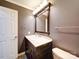 A bathroom featuring a dark vanity with marble countertop and modern fixtures at 4401 Coachwood Ln, Gastonia, NC 28056