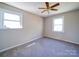 Bedroom with two windows allowing for ample natural light and a ceiling fan at 4401 Coachwood Ln, Gastonia, NC 28056