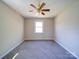 Cozy bedroom with ceiling fan, neutral walls, and a large window for natural light at 4401 Coachwood Ln, Gastonia, NC 28056