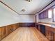 Bright kitchen with wood flooring, wood paneling, and ample space for dining or entertaining at 4401 Coachwood Ln, Gastonia, NC 28056
