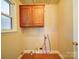 A dedicated laundry space offering hookups, cabinetry and a window for ventilation and natural light at 4401 Coachwood Ln, Gastonia, NC 28056