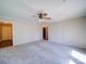 Bright, spacious living room with neutral carpet, a ceiling fan, and ample natural light at 4401 Coachwood Ln, Gastonia, NC 28056