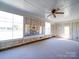 The sunroom has large windows and a ceiling fan to provide an abundance of natural light at 4401 Coachwood Ln, Gastonia, NC 28056
