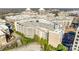 Aerial view displaying the building with roof top parking deck and greenery at 4620 Piedmont Row Dr, Charlotte, NC 28210