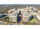 Aerial view of community with fountain, shopping areas, apartments, and parking areas at 4620 Piedmont Row Dr # 605, Charlotte, NC 28210