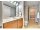 Neutral-toned bathroom with a sink vanity, tile floor, and glass door shower stall at 4620 Piedmont Row Dr # 605, Charlotte, NC 28210