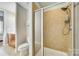 Bright bathroom featuring a shower stall with neutral tiling and a handheld shower head at 4620 Piedmont Row Dr # 605, Charlotte, NC 28210