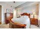 Bedroom featuring a wood frame bed, neutral tones, and bedside tables with classic lamps at 4620 Piedmont Row Dr # 605, Charlotte, NC 28210