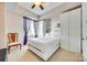 Comfortable bedroom with a platform bed, a ceiling fan and ample storage space at 4620 Piedmont Row Dr # 605, Charlotte, NC 28210