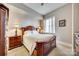 Cozy bedroom with a classic wood frame bed, carpet, and bedside tables with lamps at 4620 Piedmont Row Dr # 605, Charlotte, NC 28210