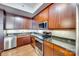 Close up of kitchen with stainless steel appliances, wood cabinets, and granite countertops at 4620 Piedmont Row Dr # 605, Charlotte, NC 28210