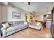 Spacious living room featuring hardwood floors, a ceiling fan and an open concept kitchen at 4620 Piedmont Row Dr # 605, Charlotte, NC 28210