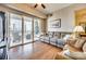 Bright living room featuring hardwood floors and a sliding door to a balcony with city views at 4620 Piedmont Row Dr # 605, Charlotte, NC 28210