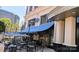 Charming outdoor dining area with umbrellas and views of the surrounding city landscape at 4620 Piedmont Row Dr # 605, Charlotte, NC 28210