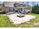 Spacious backyard featuring a stone patio, fire pit, deck, and screened in porch at 4858 Sagittarius Cir, Denver, NC 28037
