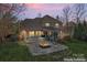 Outdoor living space with large fire pit, stone patio, and backyard at 4858 Sagittarius Cir, Denver, NC 28037